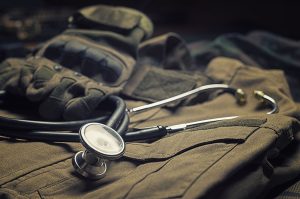 Stethoscope lies on the uniform of a Vietnam-era soldier.