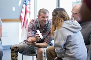 Disabled veteran shows guide to calculating your disability rating on smartphone to friends